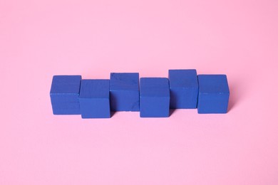 Many blank blue cubes on pink background