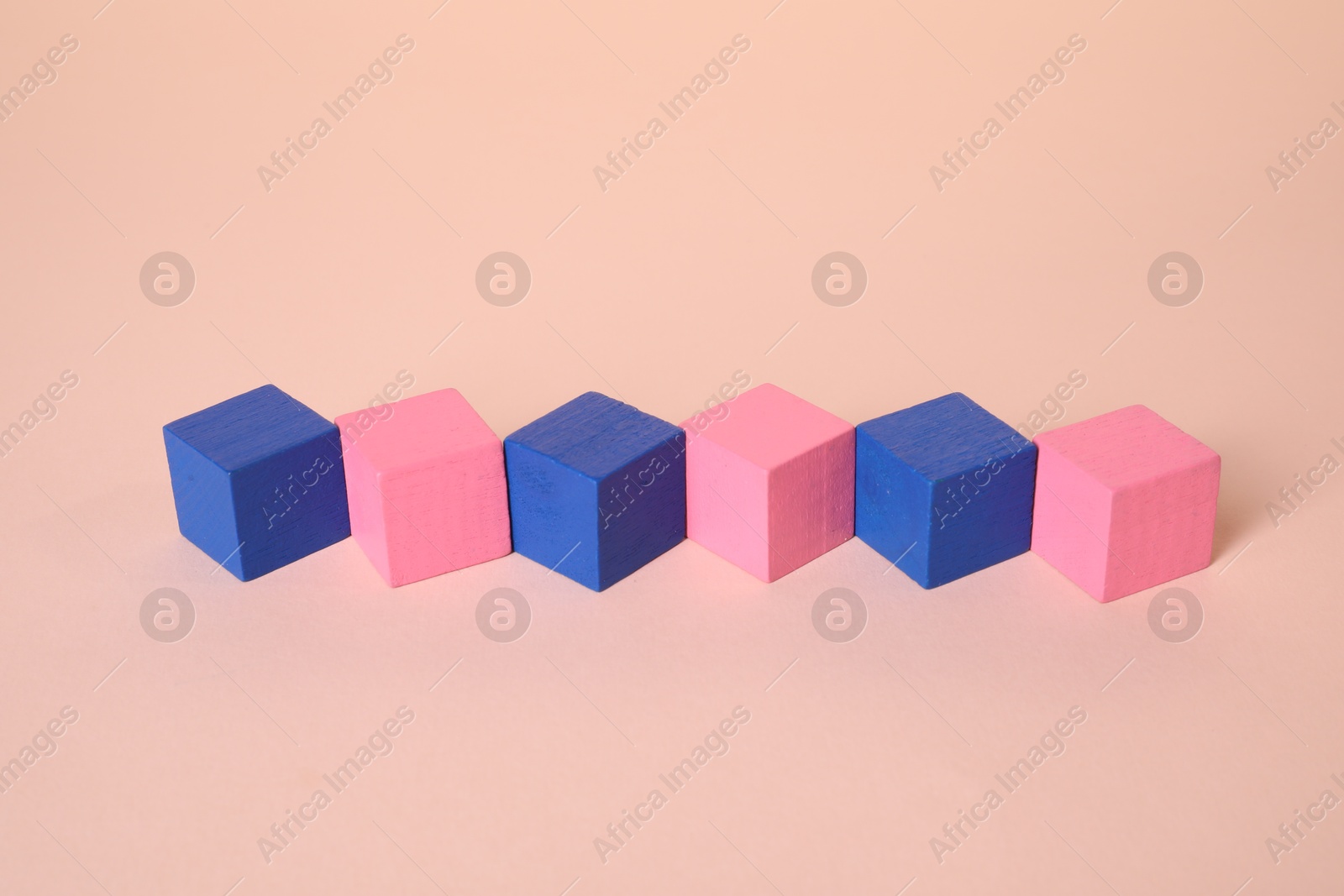 Photo of Many blank colorful cubes on beige background