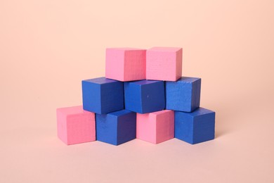 Photo of Many blank colorful cubes on beige background