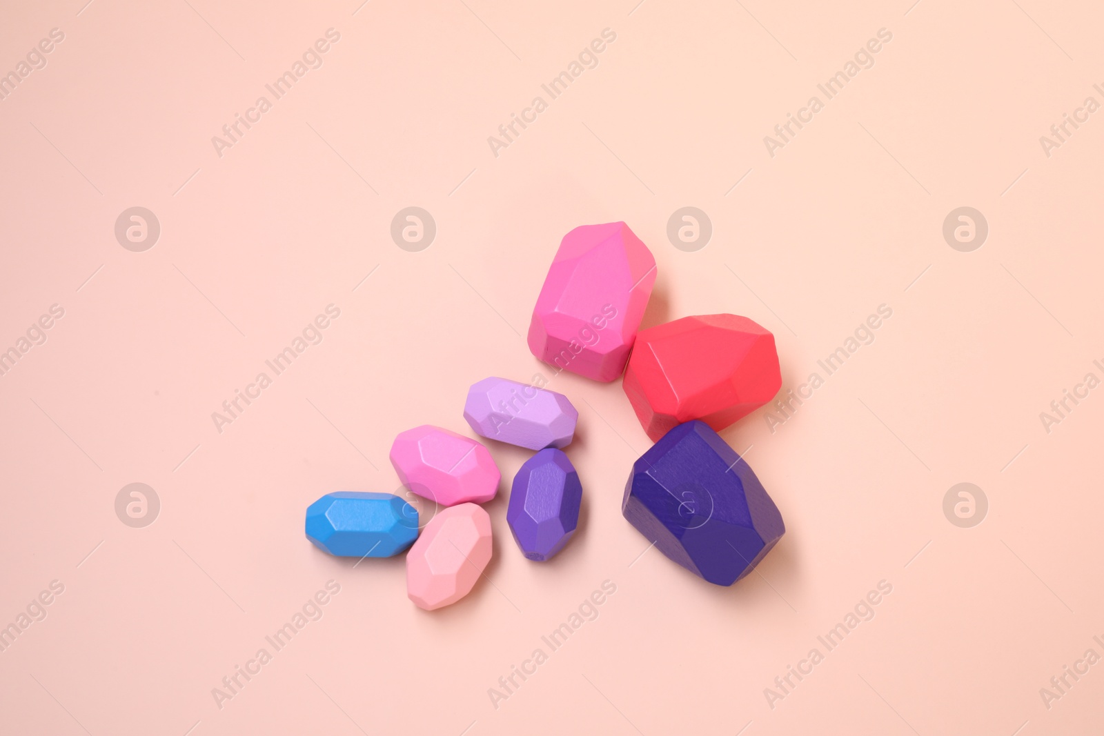 Photo of Many colorful balancing stones on beige background, top view