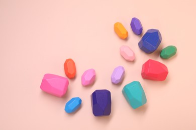 Photo of Many colorful balancing stones on beige background, top view