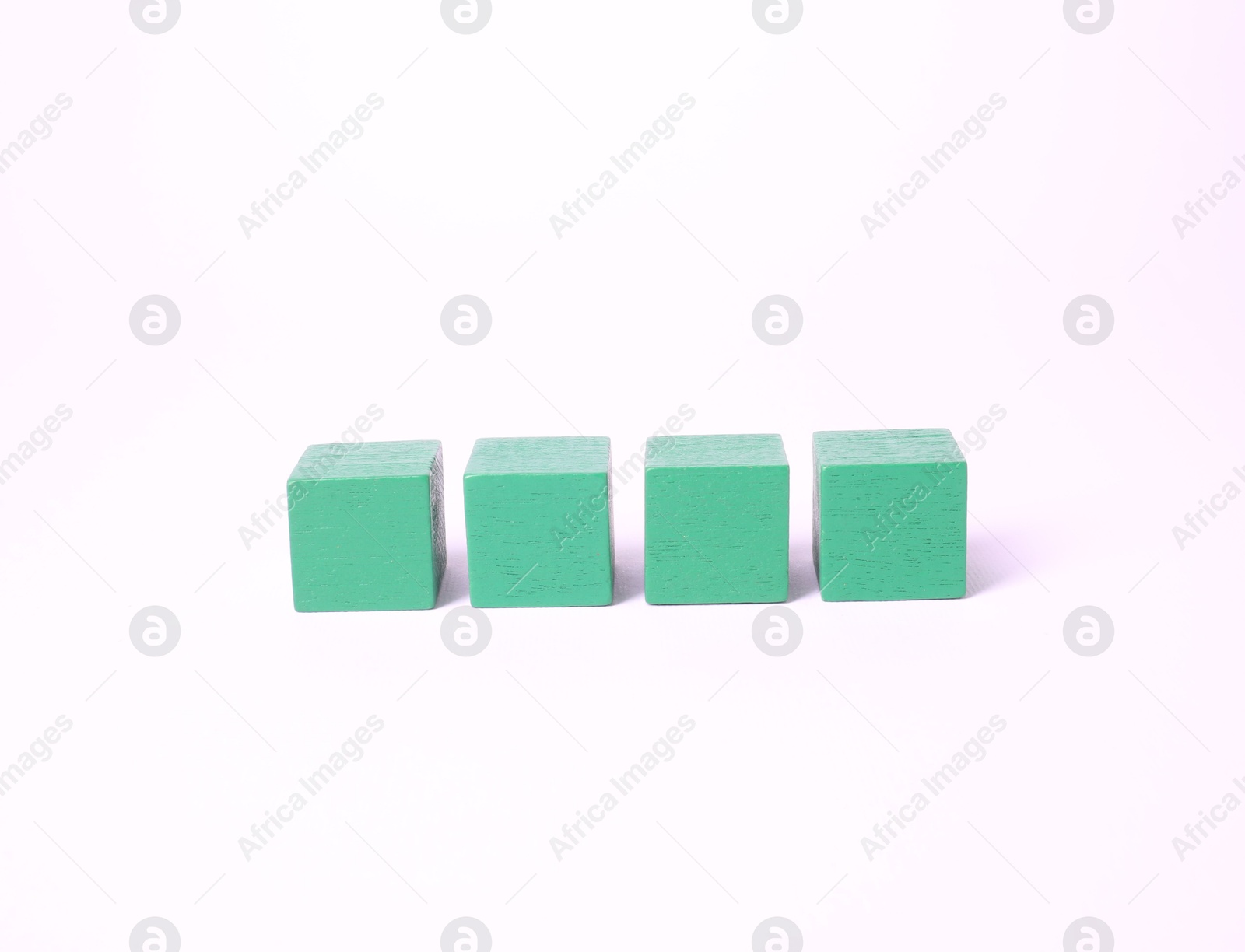 Photo of Many blank green cubes on white background