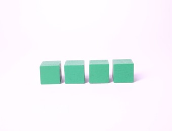 Photo of Many blank green cubes on white background