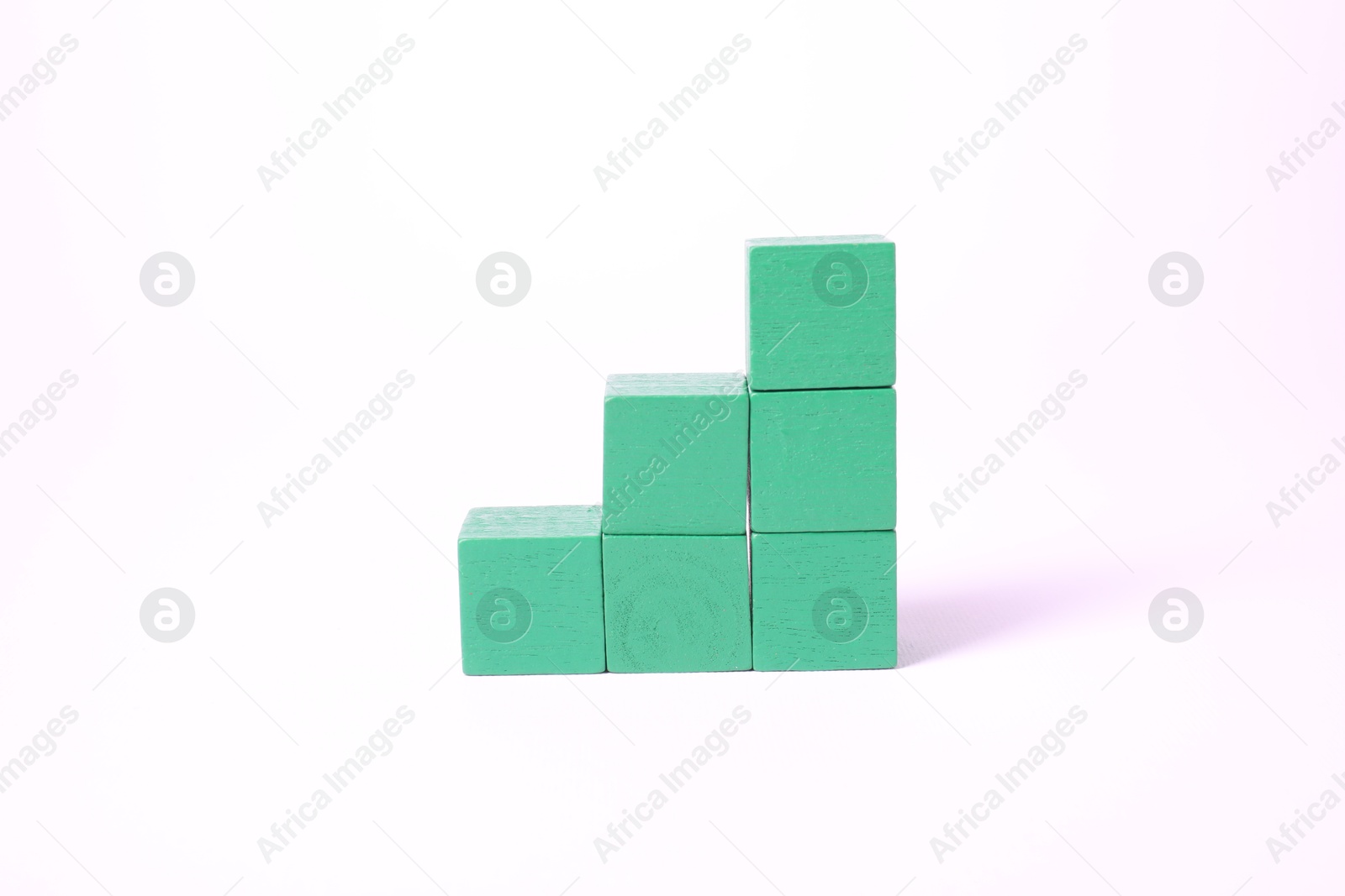 Photo of Many blank green cubes on white background