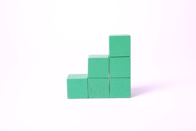 Photo of Many blank green cubes on white background