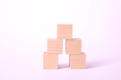 Photo of Many blank wooden cubes on white background