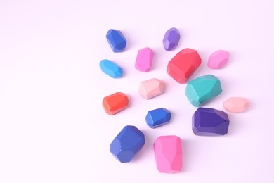 Photo of Many colorful balancing stones on white background, above view. Space for text