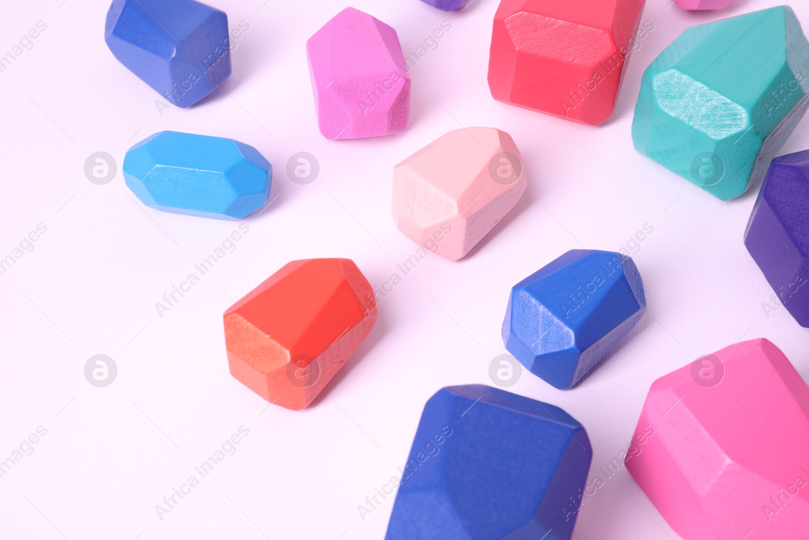 Photo of Many colorful balancing stones on white background