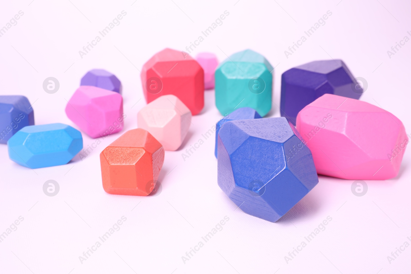 Photo of Many colorful balancing stones on white background