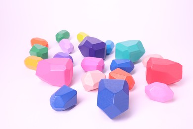 Photo of Many colorful balancing stones on white background