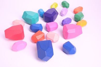 Photo of Many colorful balancing stones on white background