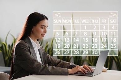 Image of Businesswoman making timetable in laptop at table. Virtual calendar near her