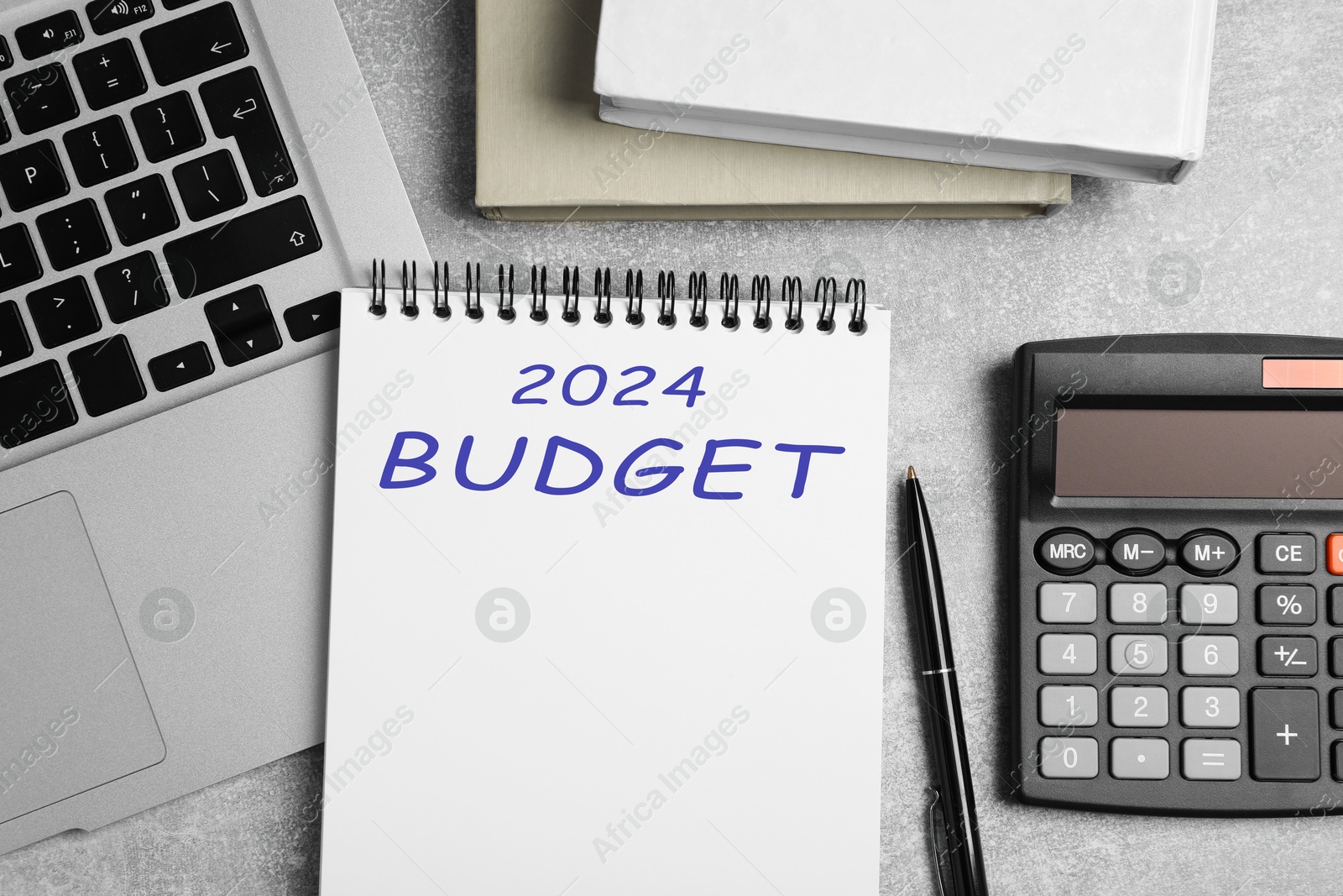 Image of Notebook with word 2024 Budget, calculator and laptop on light table, flat lay