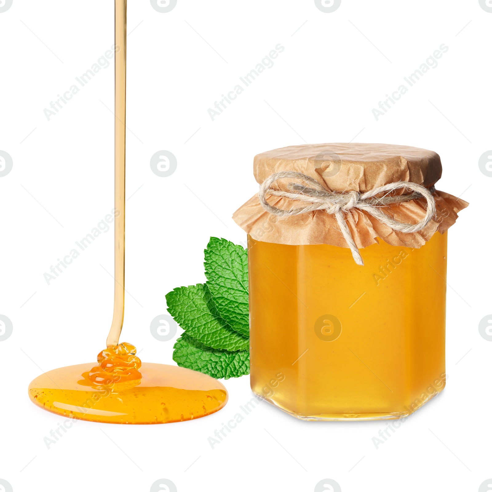 Image of Jar with honey and green leaves isolated on white