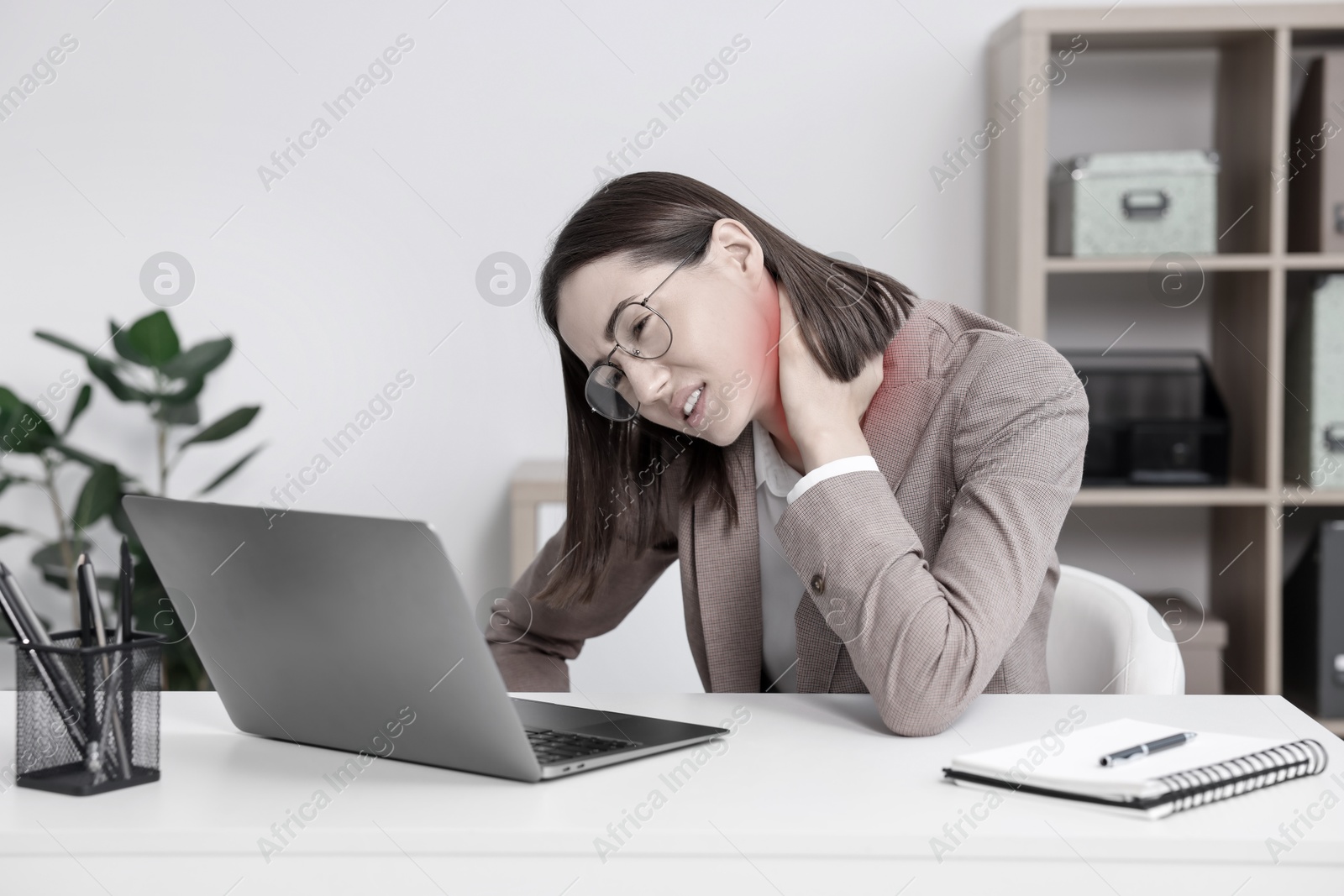 Image of Woman suffering from backache due to poor posture at workplace