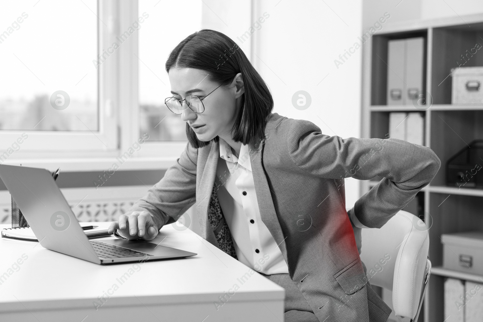 Image of Woman suffering from backache due to poor posture at workplace