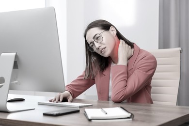 Image of Woman suffering from backache due to poor posture at workplace