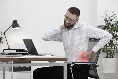 Image of Man suffering from backache due to poor posture at workplace
