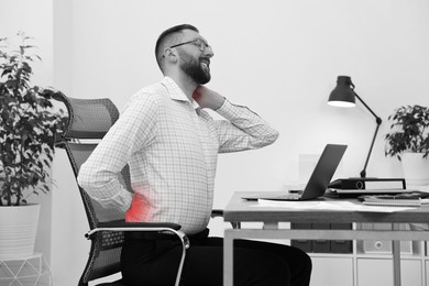 Image of Man suffering from backache due to poor posture at workplace