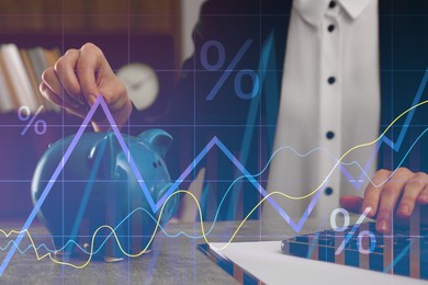 Image of Budget concept. Graphs and woman putting coin into piggy bank at table, double exposure