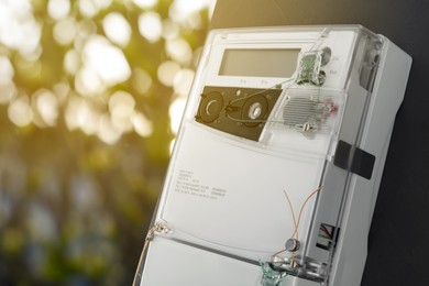 Image of Electricity meter on wall outdoors, space for text. Measuring device