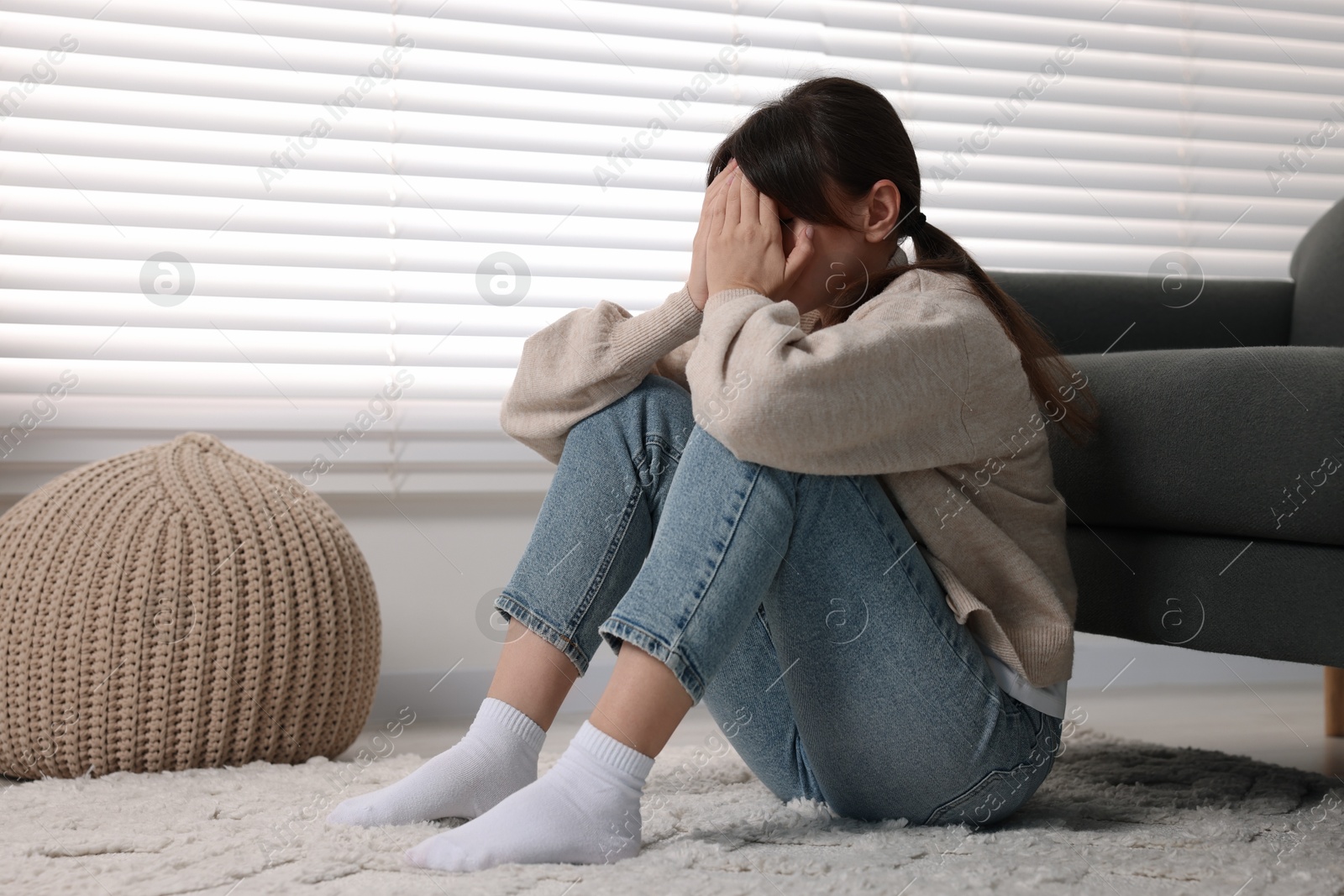 Photo of Loneliness concept. Sad woman sitting on floor at home