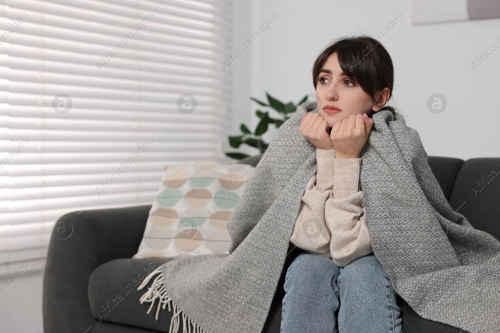 Photo of Loneliness concept. Sad woman sitting on sofa at home