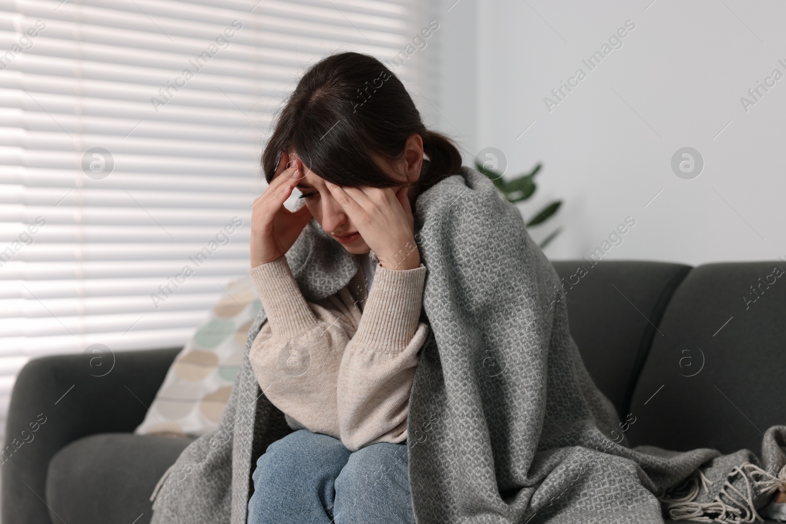 Photo of Loneliness concept. Sad woman sitting on sofa at home