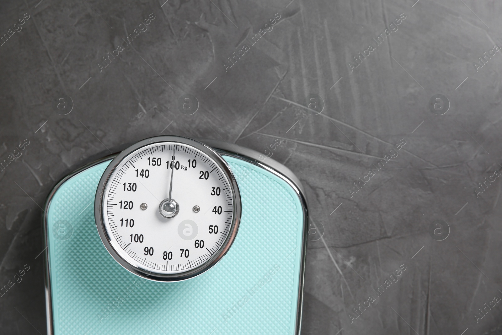 Photo of One bathroom scale on grey textured background, top view. Space for text