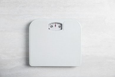 Photo of One bathroom scale on white wooden background, top view