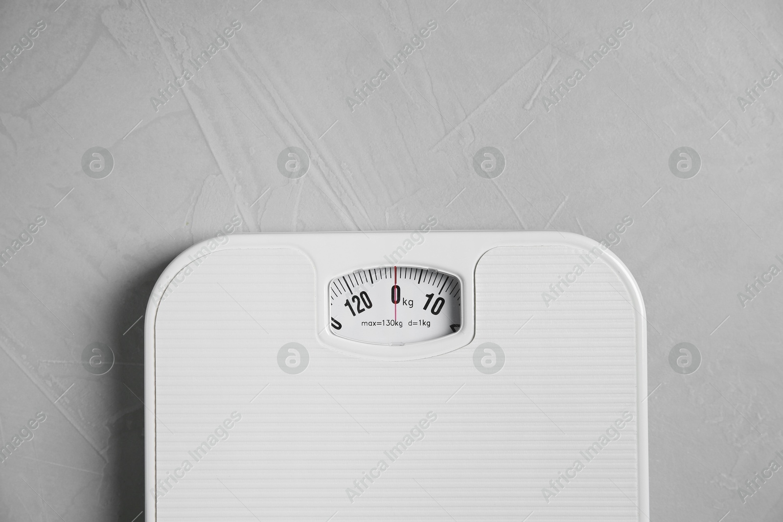 Photo of One bathroom scale on grey textured background, top view. Space for text