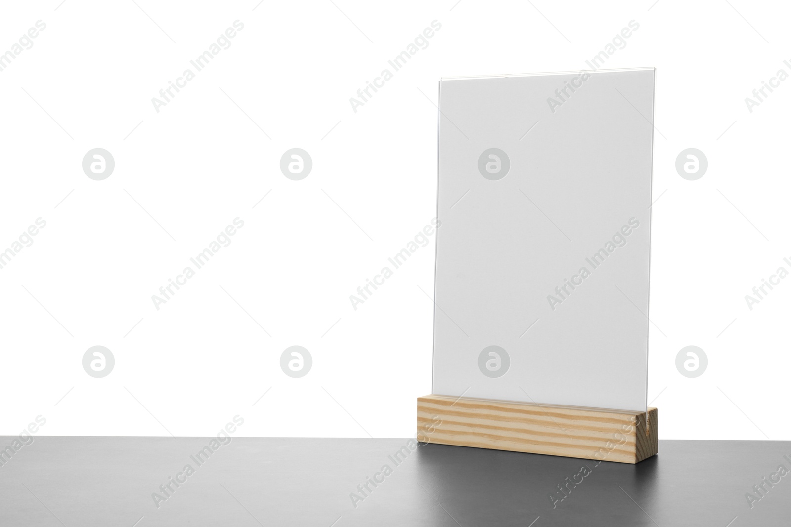 Photo of Menu holder on grey table against white background. Space for text