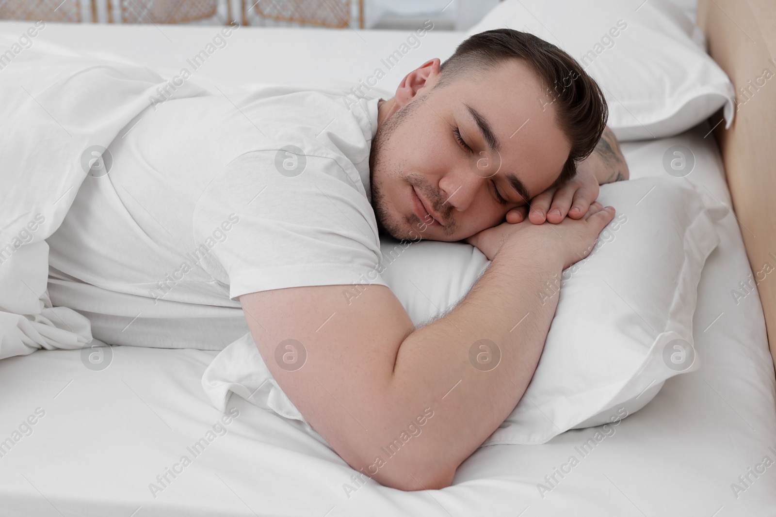 Photo of Bedtime. Handsome man sleeping in bed indoors