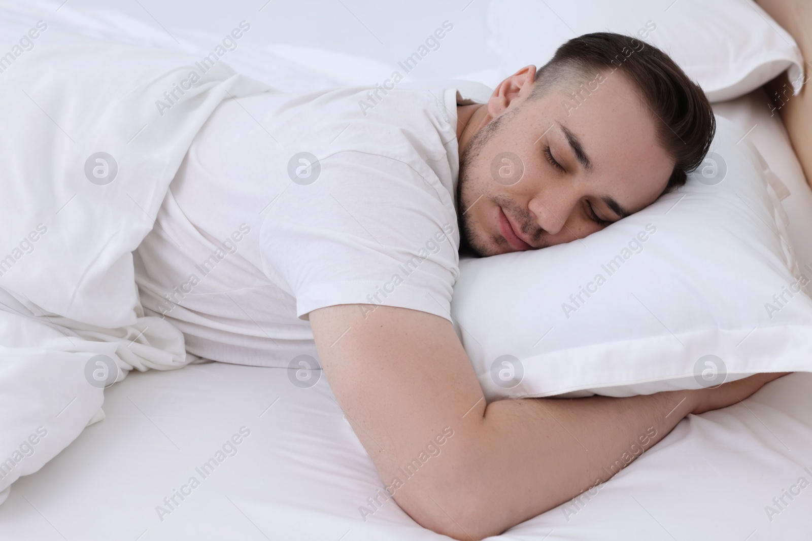 Photo of Bedtime. Handsome man sleeping in bed indoors