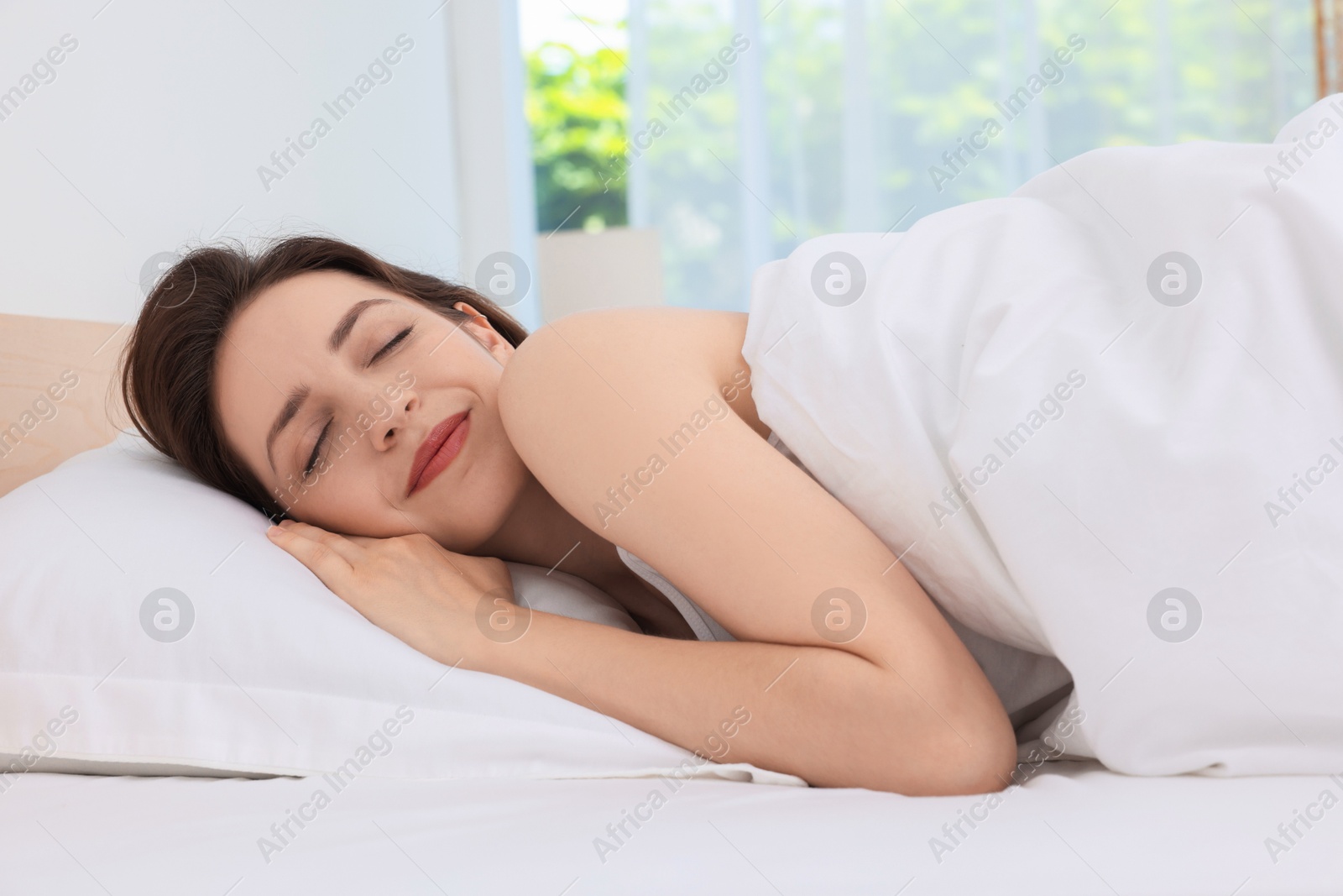 Photo of Bedtime. Woman sleeping in bed at home