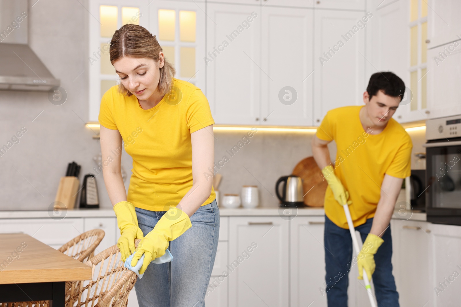 Photo of Professional janitors working in kitchen. Cleaning service