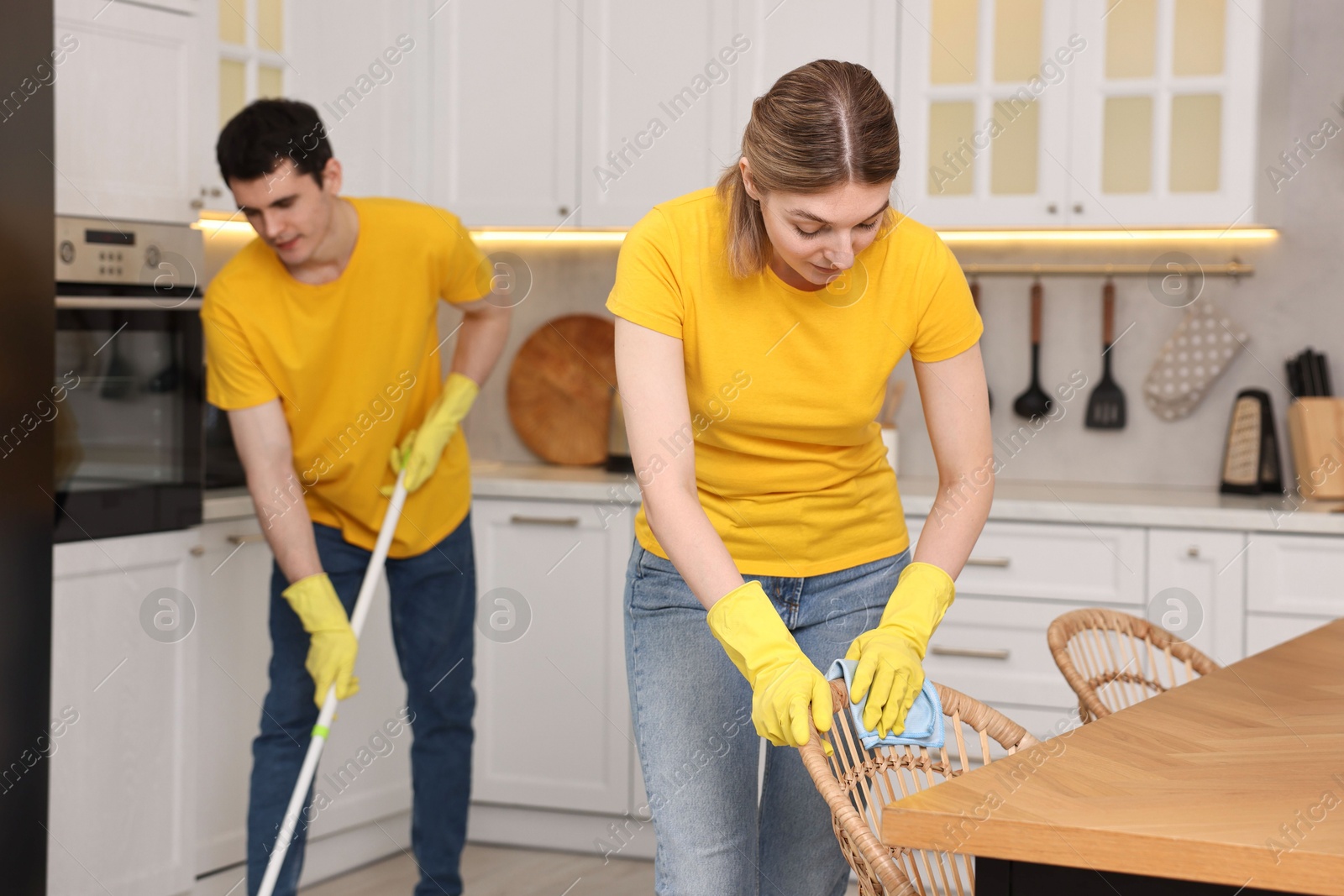 Photo of Professional janitors working in kitchen. Cleaning service