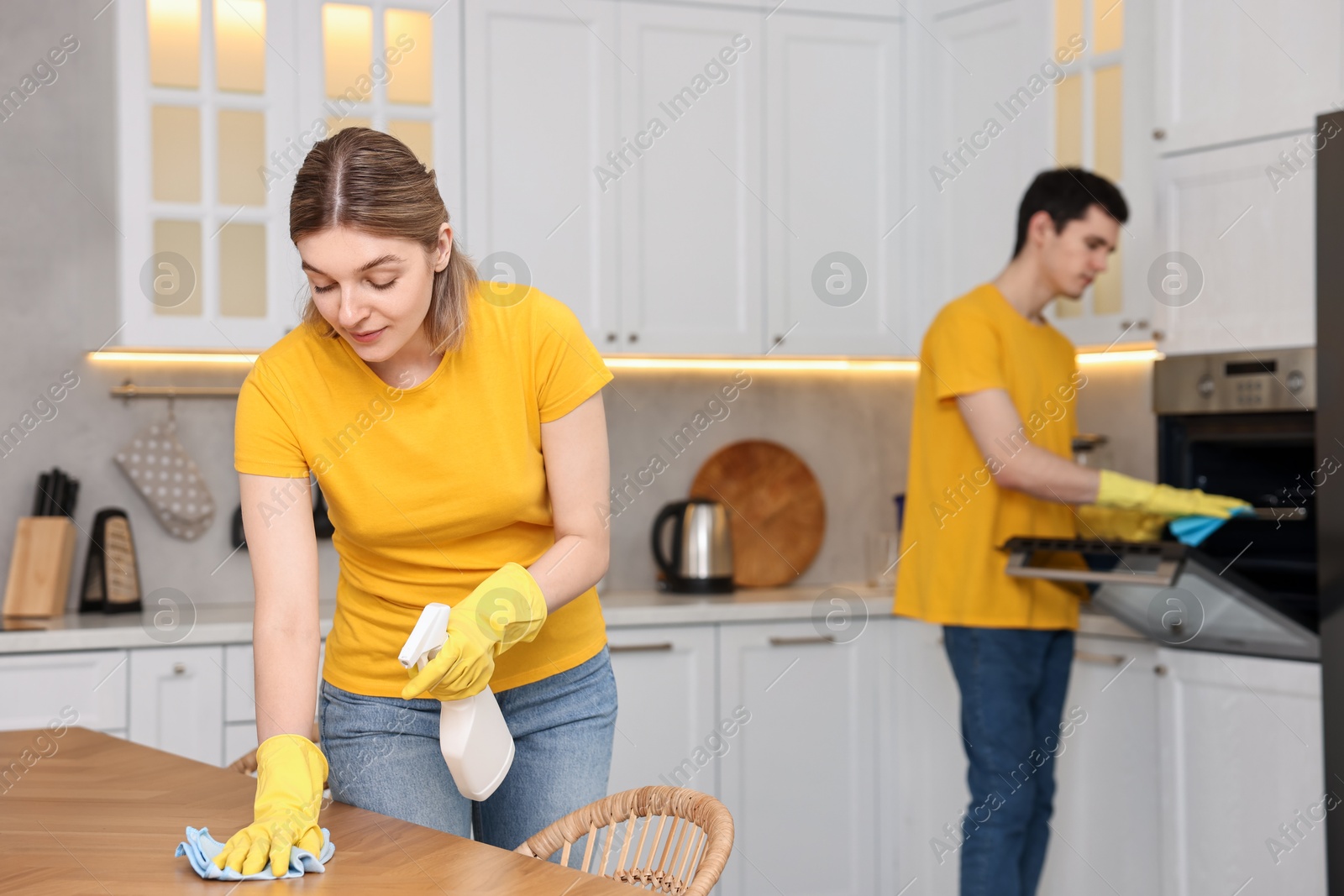 Photo of Professional janitors working in kitchen. Cleaning service