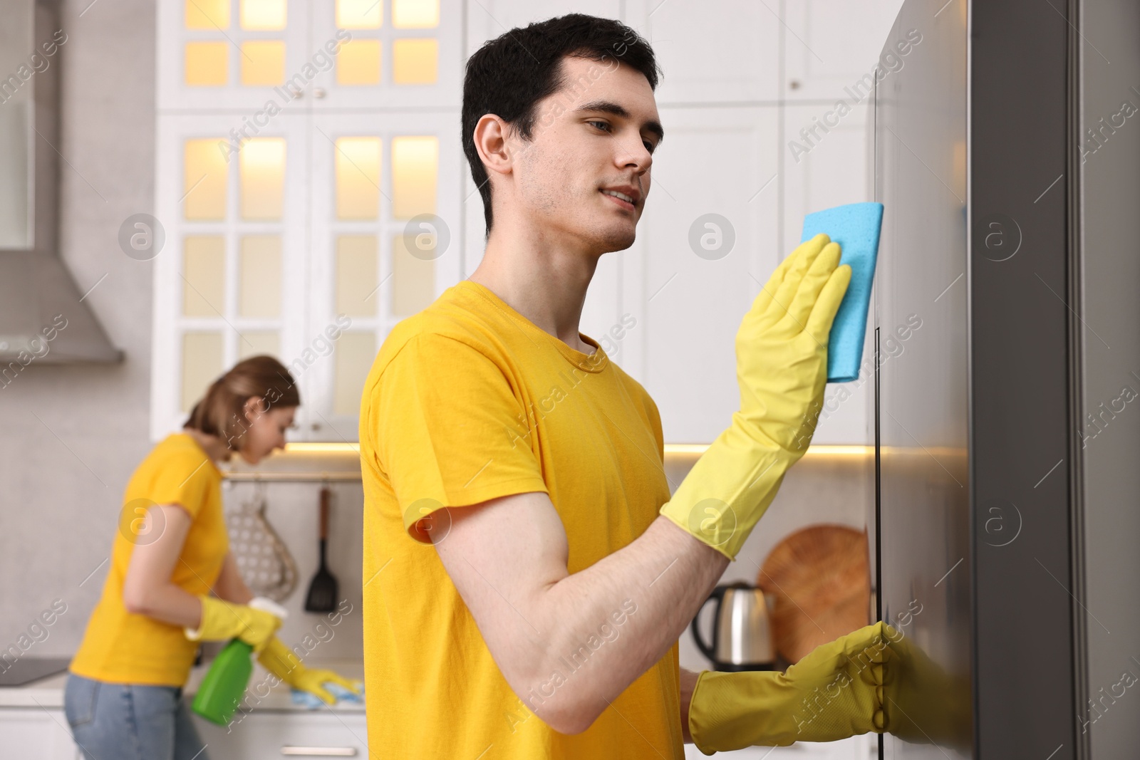 Photo of Professional janitors working in kitchen. Cleaning service