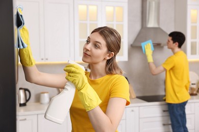Photo of Professional janitors working in kitchen. Cleaning service