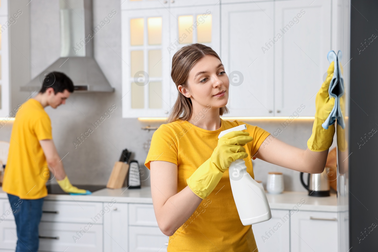 Photo of Professional janitors working in kitchen. Cleaning service