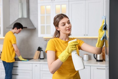 Photo of Professional janitors working in kitchen. Cleaning service