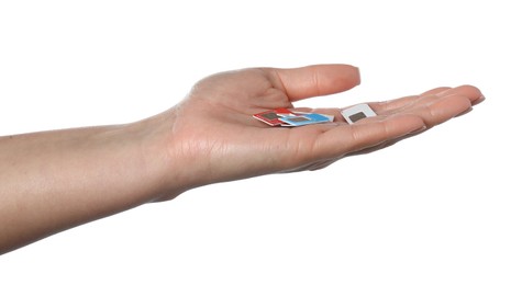 Photo of Woman with SIM cards on white background, closeup