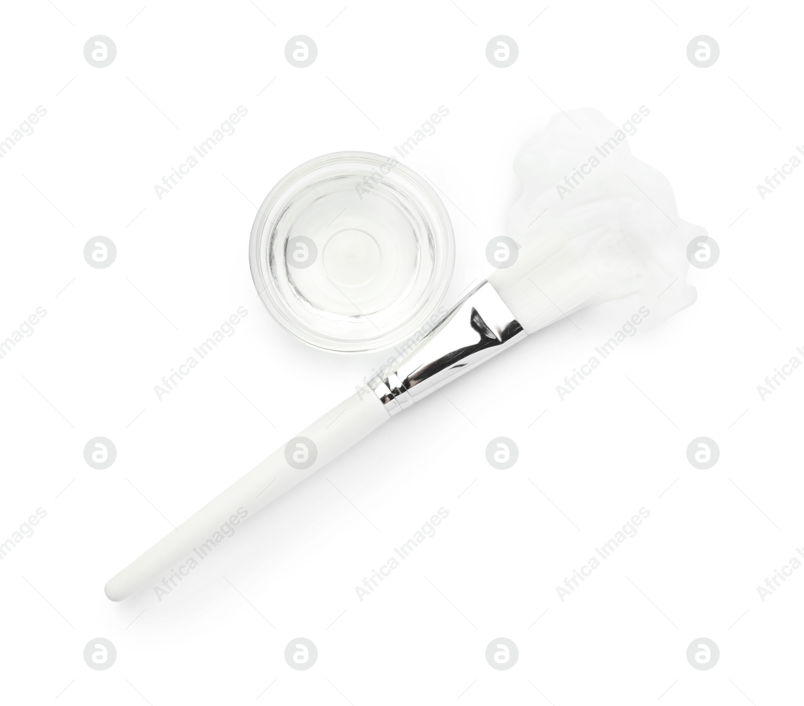 Photo of Bowl of chemical peel and brush isolated on white, top view. Peeling procedure