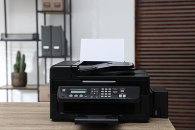 Photo of Modern printer with paper on table in office