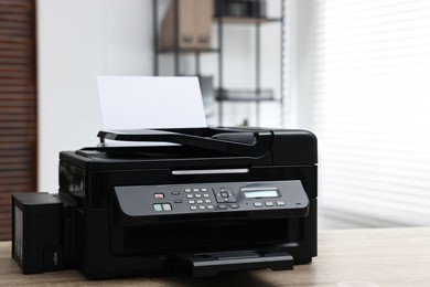 Photo of Modern printer with paper on table in office