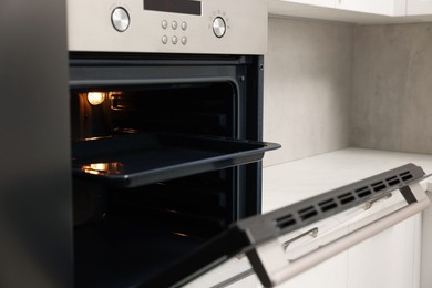 Open electric oven in kitchen. Cooking appliance