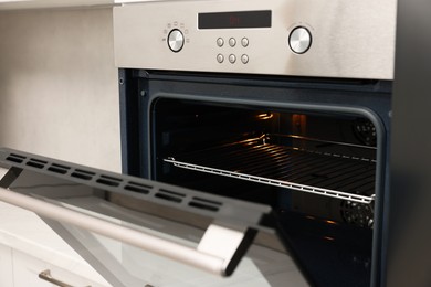 Photo of Open electric oven in kitchen. Cooking appliance