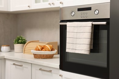 Electric oven with towel in kitchen. Cooking appliance