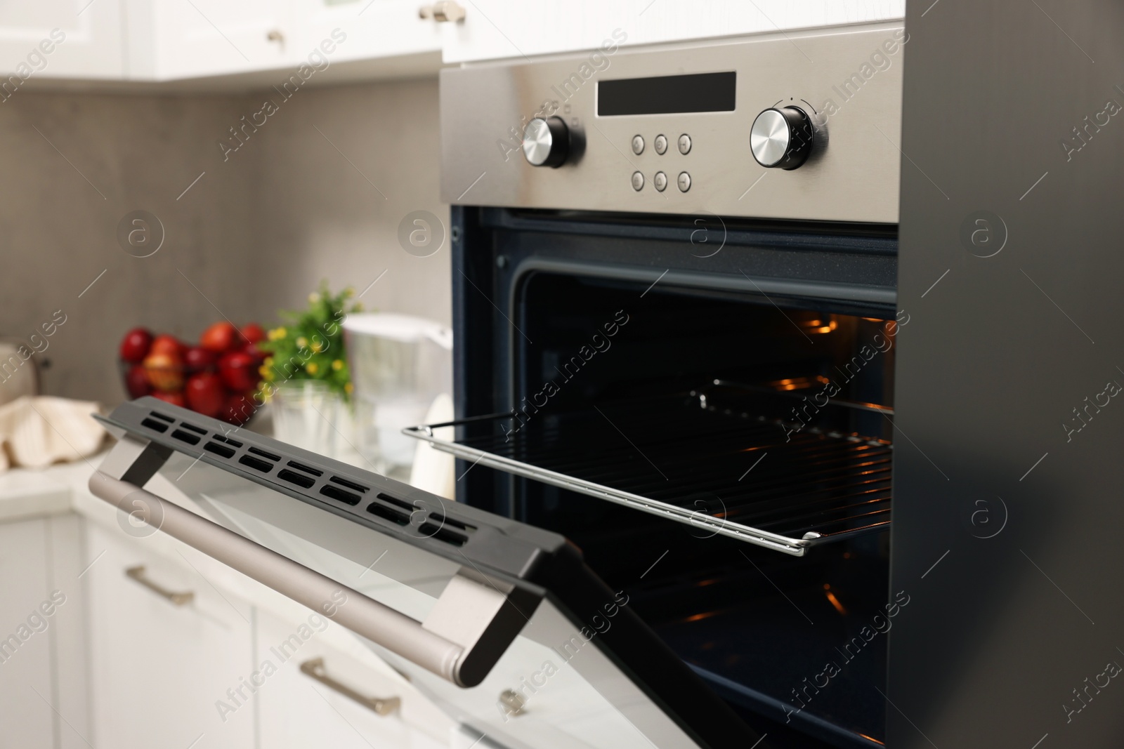 Photo of Open electric oven in kitchen. Cooking appliance